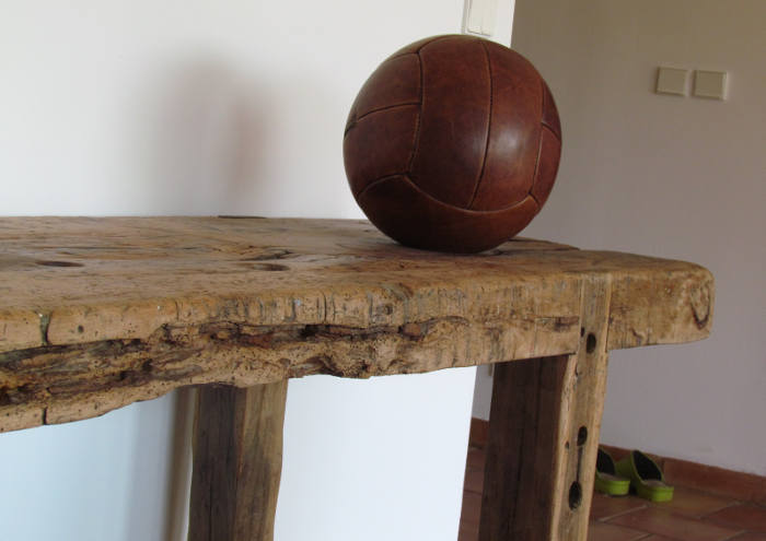 Old leather volleyball on wooden furniture