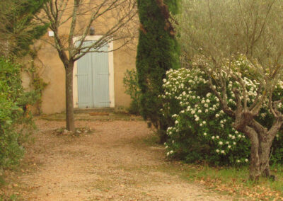 entrance of a house in Provence in the middle of a luxuriant vegetation