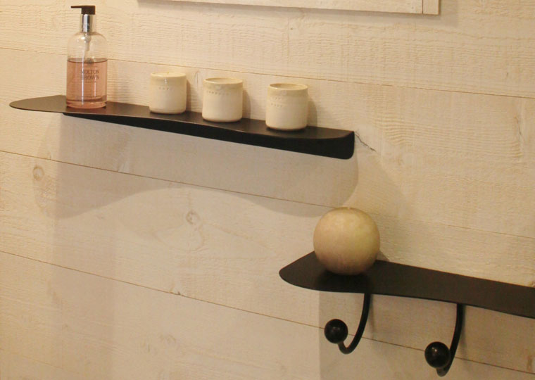 Close-up on black metal wall shelves in organic shape