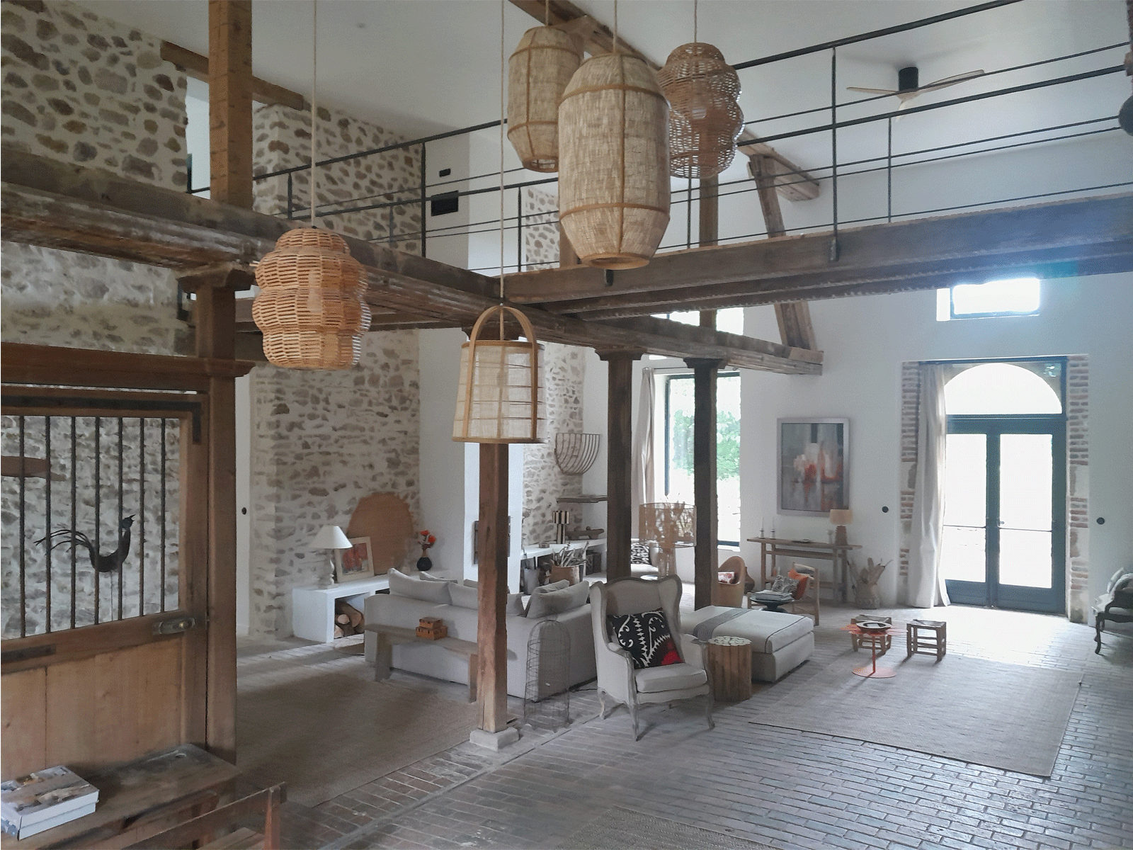 anciennes remises transformées en habitation composées d'un grand living avec une passerelle à l'étage pour accéder au coin nuit